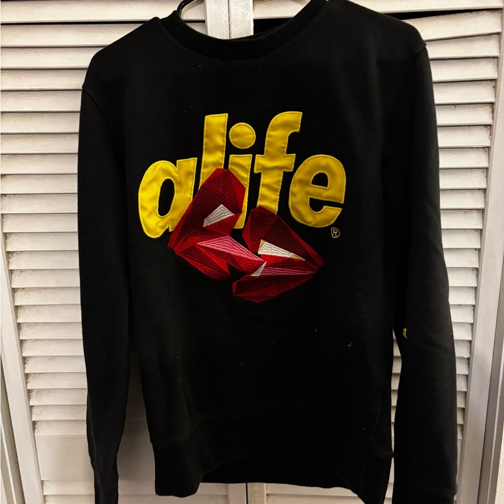 Alife Women's Black Sweater with Vibrant Yellow and Red Design